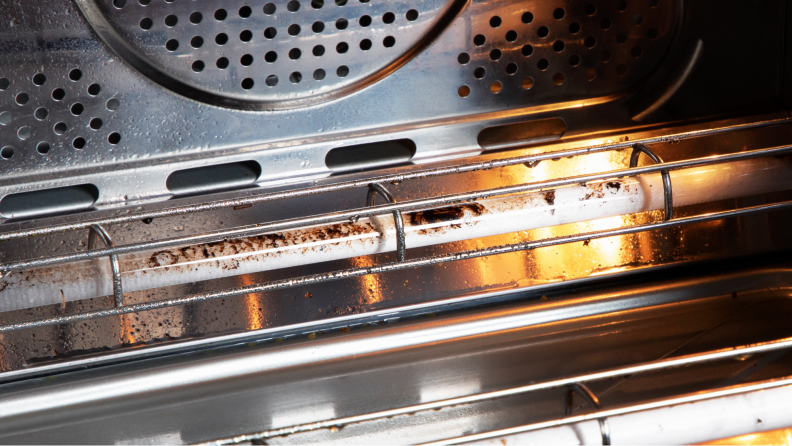 The dirty insides of the GE Profile smart oven, showing grease accumulated on the heating element.