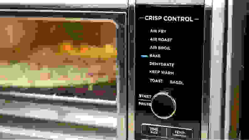 A pizza cooks in a Ninja Foodi oven